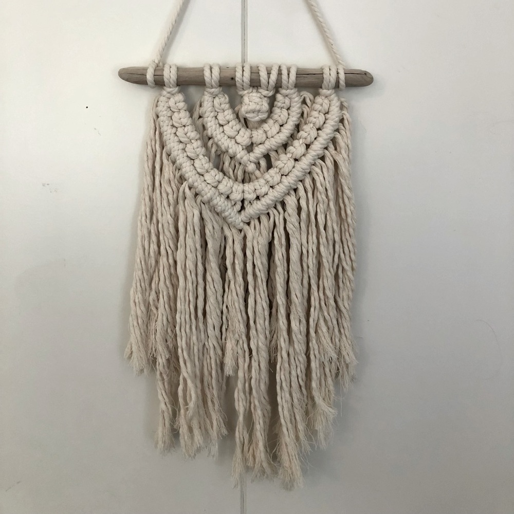 Macramé wall hanging on driftwood stick